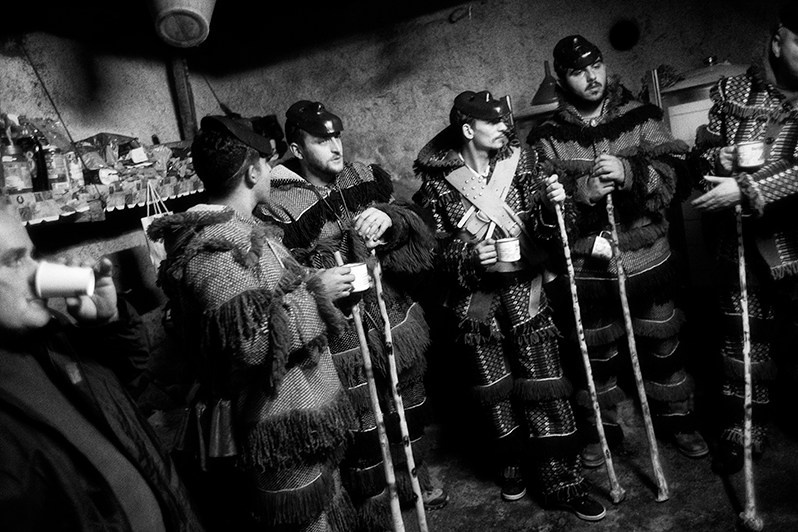 The “Caretos” inside a wine cellar drinking wine, Macedo de Cavaleiros municipality, Bragança district, Trás-os-Montes region, Portugal. 2022