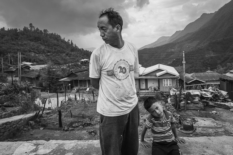 A villager and his son from Ramlau who had his house and belongings burned and destroyed by the Myanmar military 3 weeks ago, Ramlau village, Falam township, Chin state, Myanmar. May 2023