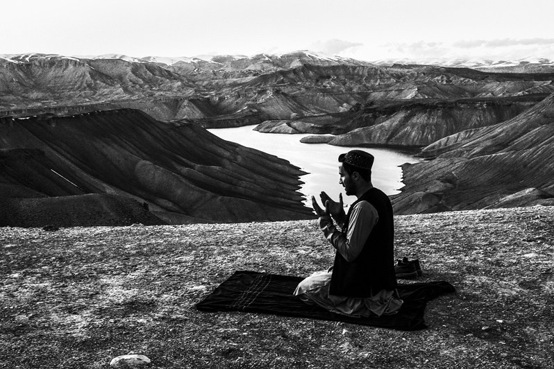 Afghans pray wherever necessity catches up with them, Bandi Amir, Bamyan province, Afghanistan. 2024