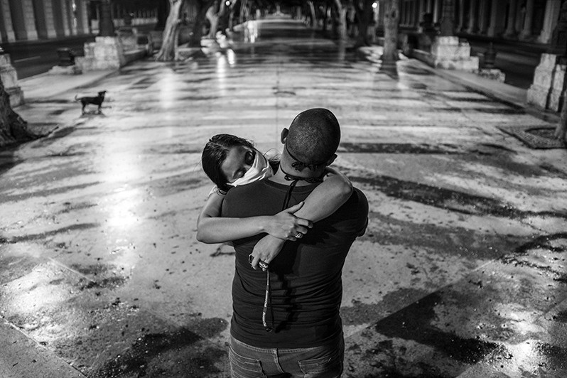 Couple on a curfew walk during the Covid-19 pandemic, Paseo del Prado promenade, Centro Habana district, Havana, Cuba. 2020