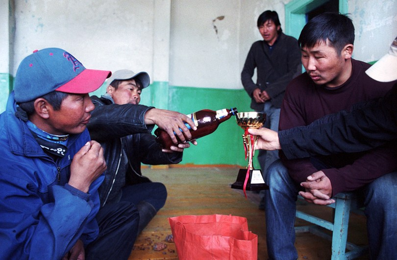 A beer party at a local school using a sports cup, Khatgal village, Khövsgöl province, Mongolia. September 2011