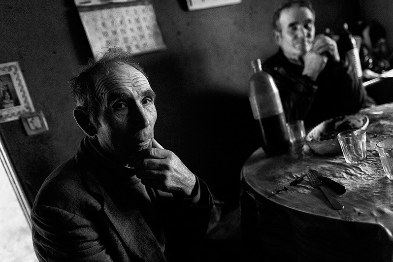 Men sitting at the kitchen table after a morning's work, Boticas municipality, Vila Real district, Trás-os-Montes region, Portugal. 2015