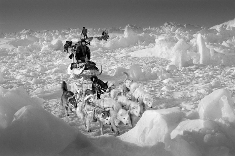 Polar bear hunters, Hjelmer and Isak, on rough packed ice on the east coast of Greenland, near Scorebysund, Sermersooq municipality, Greenland, Kingdom of Denmark. 1995