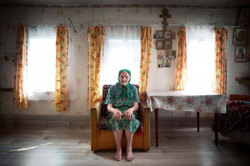 Nina Davydova, 80, old believer poses in her house, Chuprovo village, Udorsky district, Komi Republic, Russia. 2020