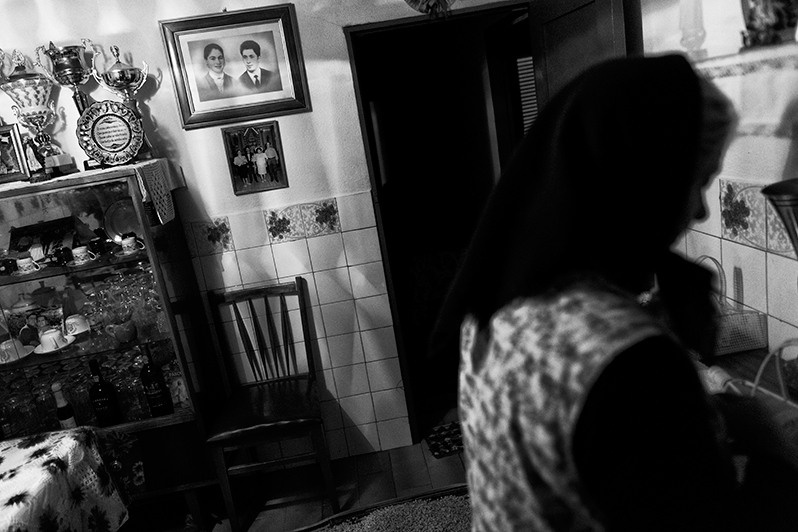 Woman getting ready to visit her family at the cemetery, Boticas municipality, Vila Real district, Trás-os-Montes region, Portugal. 2015