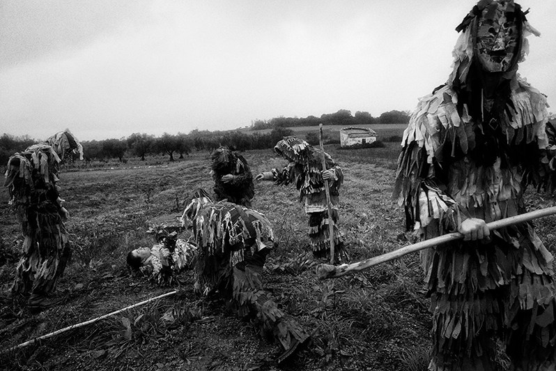 The “Caretos” try to lift a colleague from the ground, Bragança municipality, Bragança district, Trás-os-Montes region, Portugal. 2023