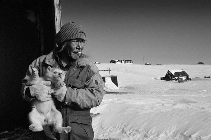 Bent with puppy in Itterajivit, Cape Hope village, Sermersooq municipality, Greenland, Kingdom of Denmark. 1995