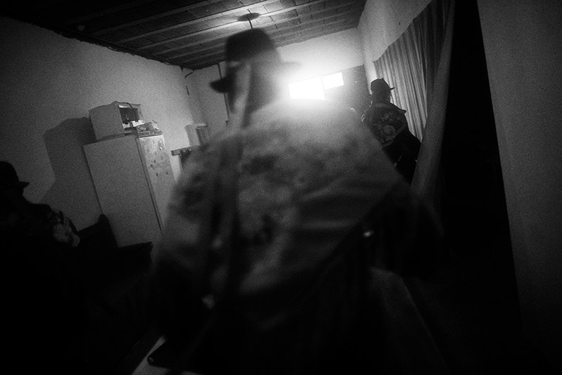 The “Moços” sing and dance around a table full of food and drinks as a way of greeting the owners of the houses, Vinhais municipality, Bragança district, Trás-os-Montes region, Portugal. 2017