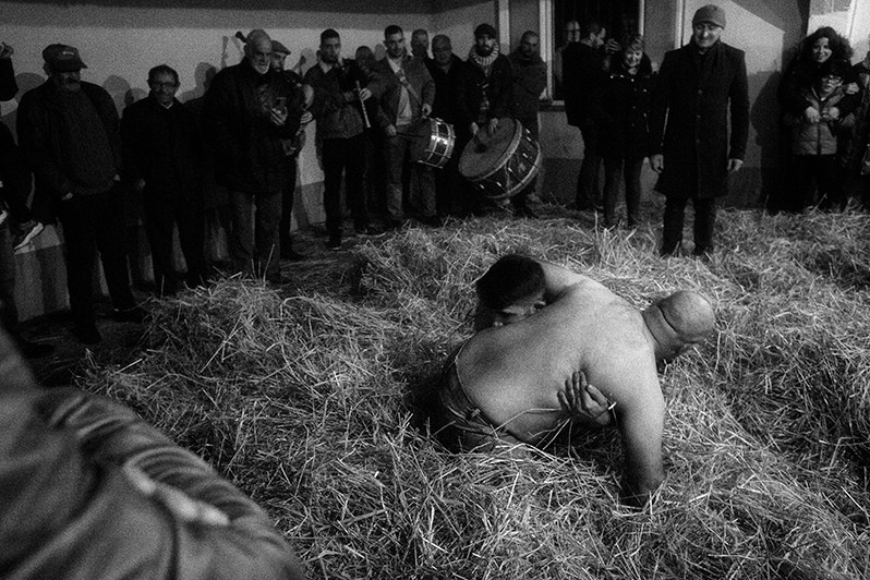 Villagers follow the two boys in “Galhofa” with all their attention, Bragança municipality, Bragança district, Trás-os-Montes region, Portugal. 2022