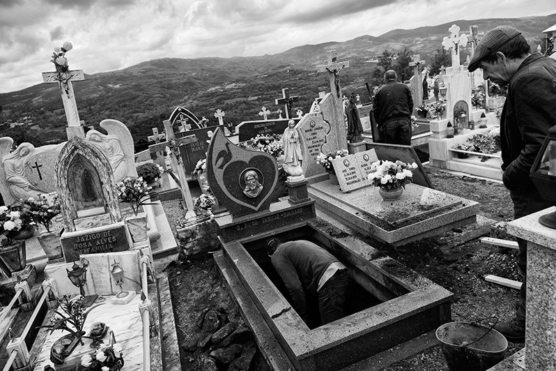 Men dig earth from a grave, Montalegre municipality, Vila Real district, Trás-os-Montes region, Portugal. 2016