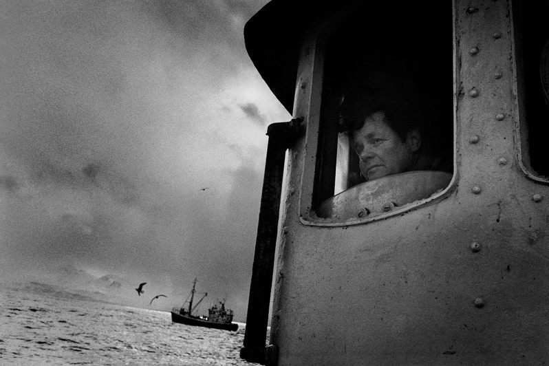 Finnur Gærdbo peeks out the window of his boat Kristján HU 123, near Ólafsvík, Snæfellsbær municipality, Vesturland region, Iceland. 1991