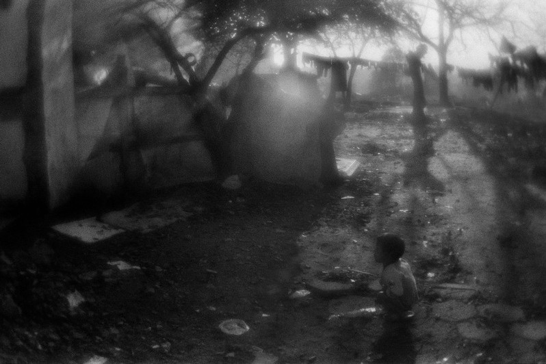 Gypsy child plays in the courtyard of the temporary dwelling, Fener, Fatih district, Istanbul province, Marmara region, Turkey. November 2009