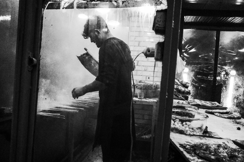 Cooking meat on the streets of the capital, Kabul, Afghanistan. 2024