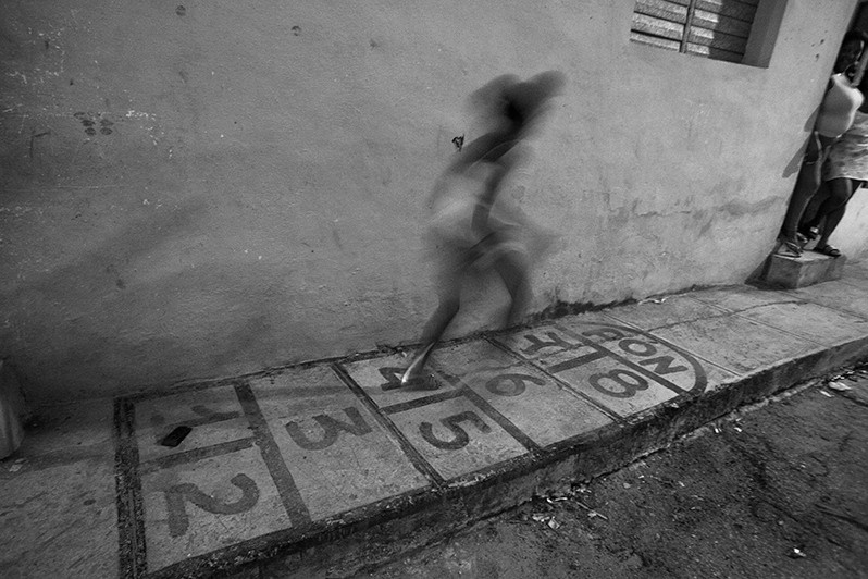 Girl playing "pony" in one of Havana's central neighbourhoods, Centro Habana district, Havana, Cuba. 2017