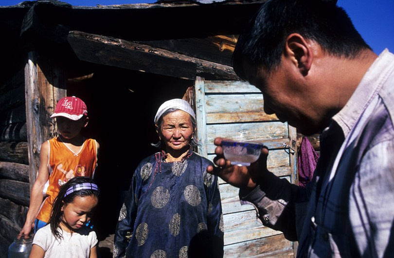 A bowl of homemade vodka is a traditional treat in the steppe, Tsagaan-Üür district, Khövsgöl province, Mongolia. October 2010