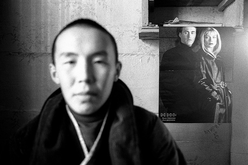 Portrait of a Buddhist student in his room, Verkhnyaya Ivolga village, Buryatia, Russia. November 2001