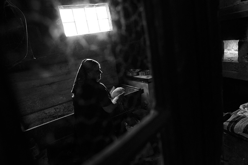 Woman prepares bread dough for baking in her wood-fired oven, Bragança district, Trás-os-Montes region, Portugal. 2016