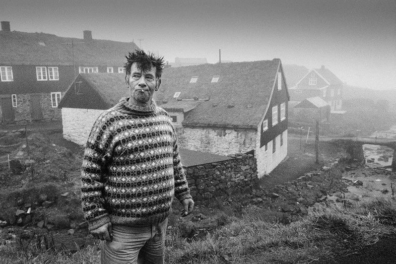 Jógvan Meinard Johannesen smoking a cigarette in the drizzling rain, Mykines village, Sorvagur region, Faroe Islands. 1996
