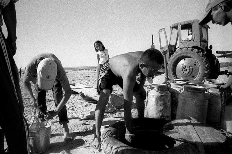 Families who take advantage of a tractor, Tastubek village, Aralsk district, Kyzyl-Orda region, Kazakhstan. August 2001