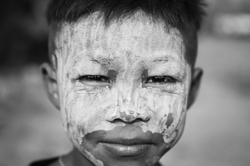 A Karen boy with thanaka on his face, Kayin state, Myanmar. March 2019