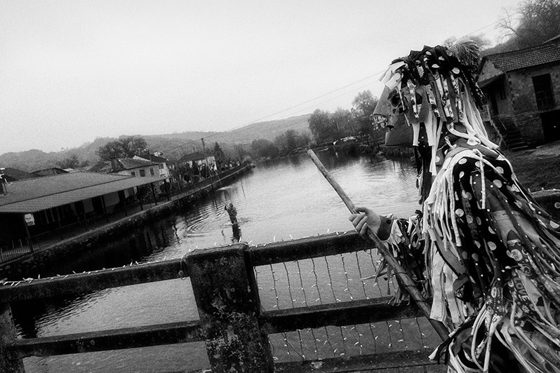 Despite the intense cold, the “Caretos” show courage by entering the river, Bragança municipality, Bragança district, Trás-os-Montes region, Portugal. 2017