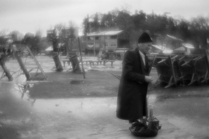 A man is drinking wine in the marketplace on non-trading day, Beykoz, near Istanbul, Turkey. January 2008