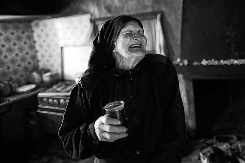 Woman with a glass of wine smiling with happiness, Boticas municipality, Vila Real district, Trás-os-Montes region, Portugal. 2016