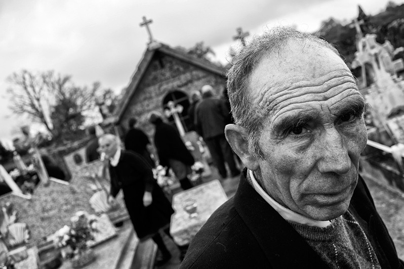 Man at the cemetery visiting his deceased family members, Boticas municipality, Vila Real district, Trás-os-Montes region, Portugal. 2016