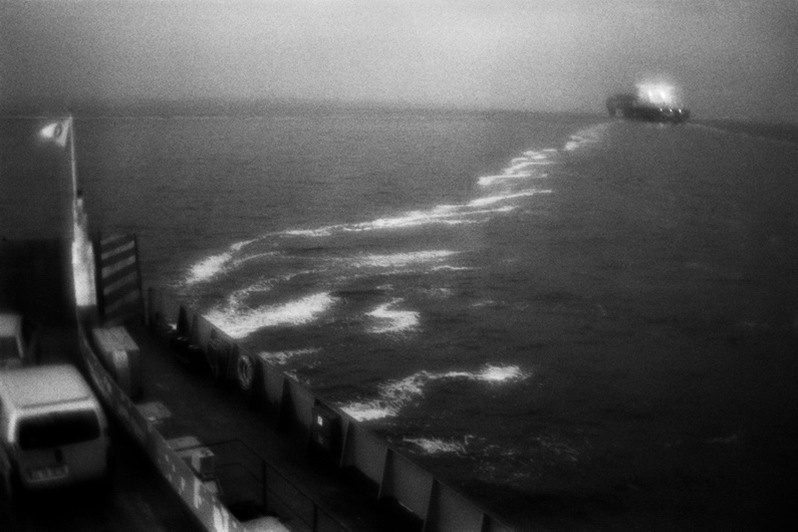 View from car ferry to the container ship going through Dardanelles, Denizli province, TurkeyJanuary 2011