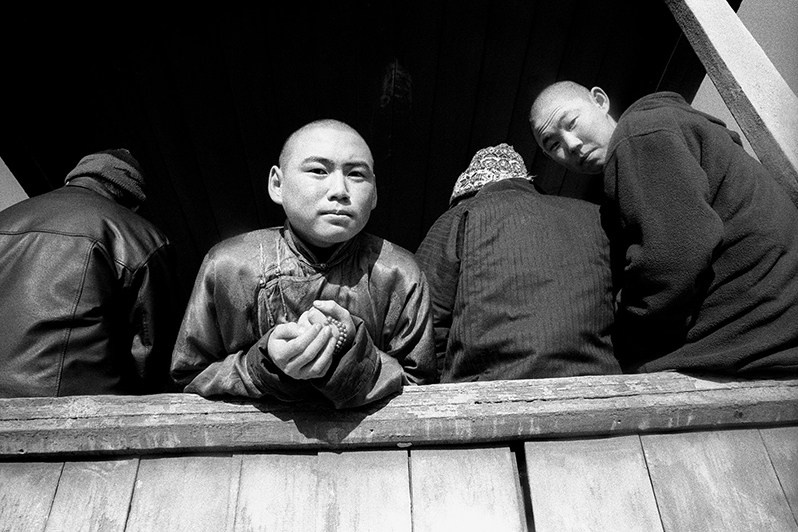 Buddhist monks at recess waiting for class to start during afternoon maths and chemistry classes, Verkhnyaya Ivolga village, Buryatia, Russia. November 2001
