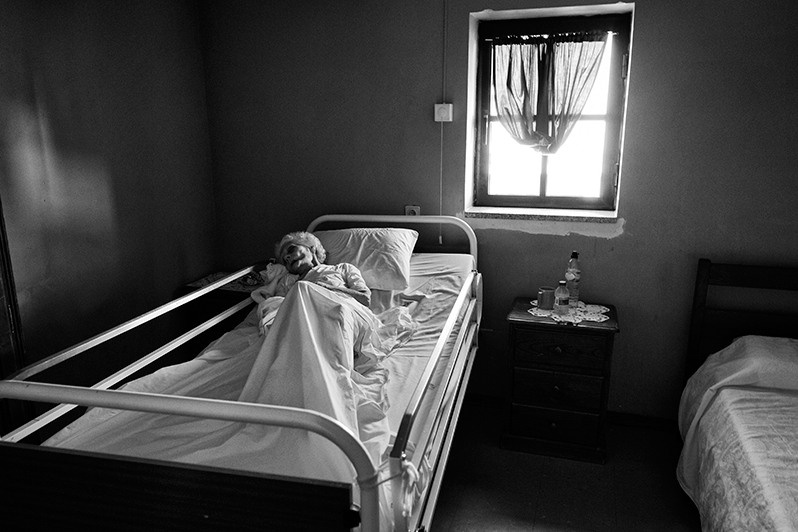Elderly woman relaxing in her room at nursing home, Bragança district, Trás-os-Montes region, Portugal. 2015