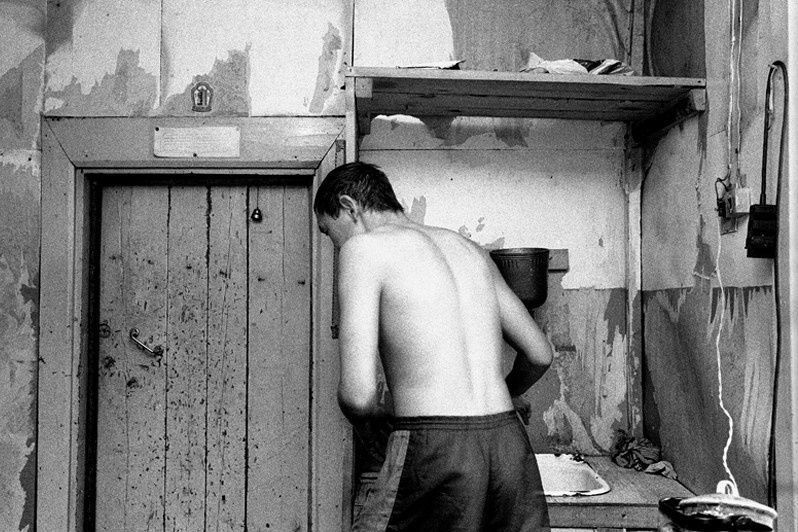 20:00. At the end of the school day, a Buddhist monk, if he is alone, takes a moment to wash and do his laundry, Verkhnyaya Ivolga village, Buryatia, Russia. November 2001