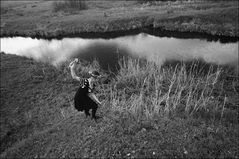 "The girl collecting flowers on a river slope for weaving of wreaths", farm of Senshin, village of Oblivskaya district, Rostov-on-Don region, Russia, May 2011