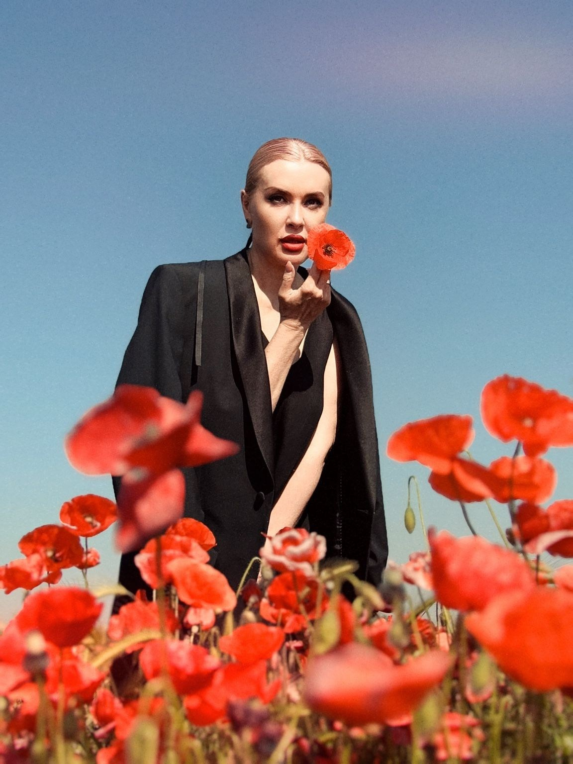 Portrait photoshoot in Plovdiv – professional portrait of a woman among red flowers