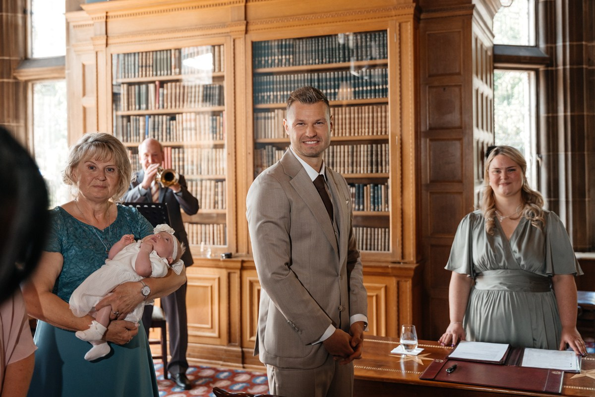 groom is waiting for her bride with guests