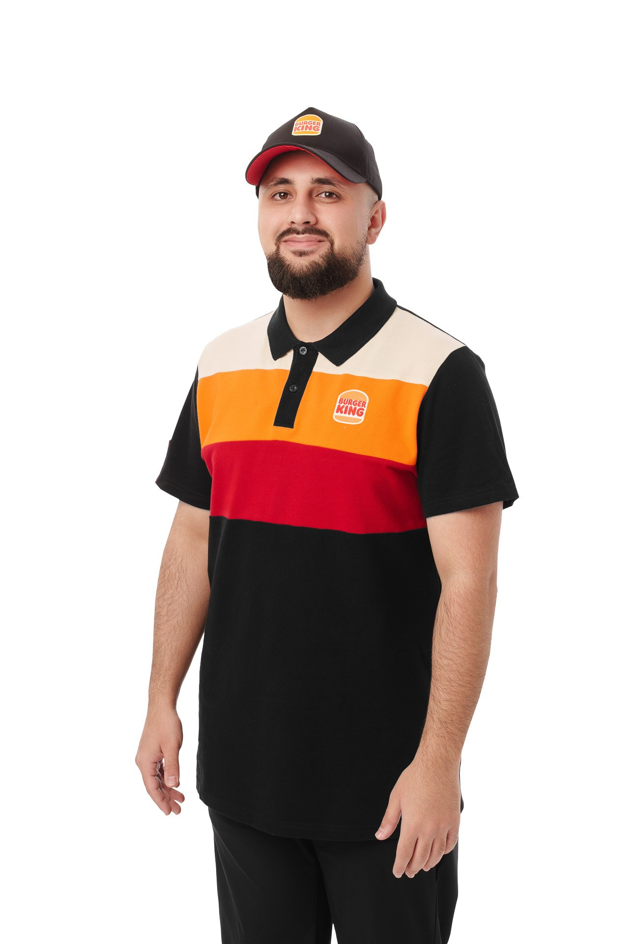 Burger King employee in branded polo shirt and cap, studio portrait