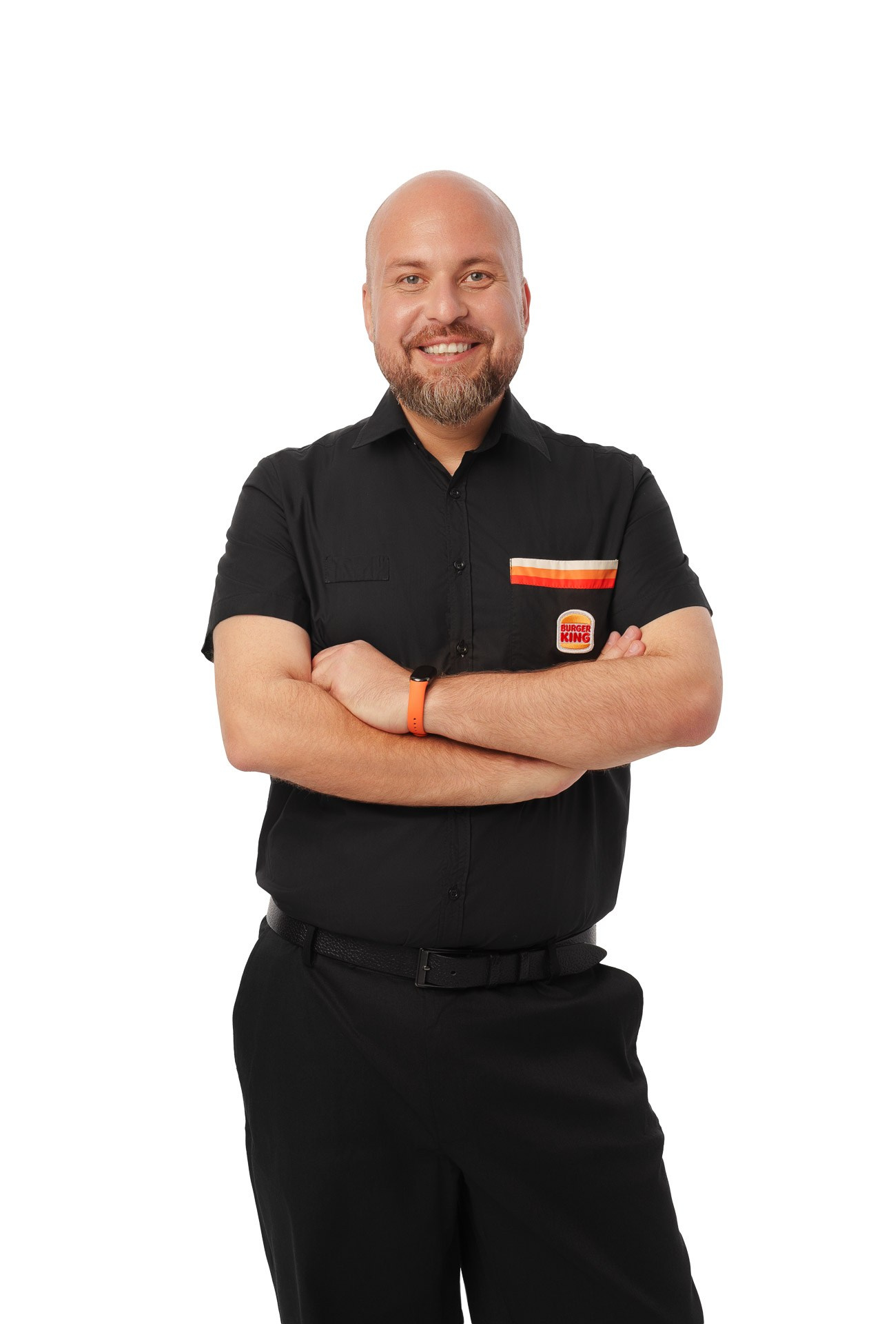 Burger King manager in black uniform with arms crossed, studio portrait