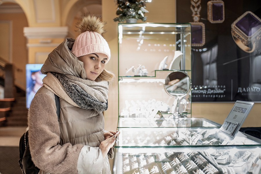 Fashion photoshoot of a woman near a shop window. Trendy and atmospheric street photography