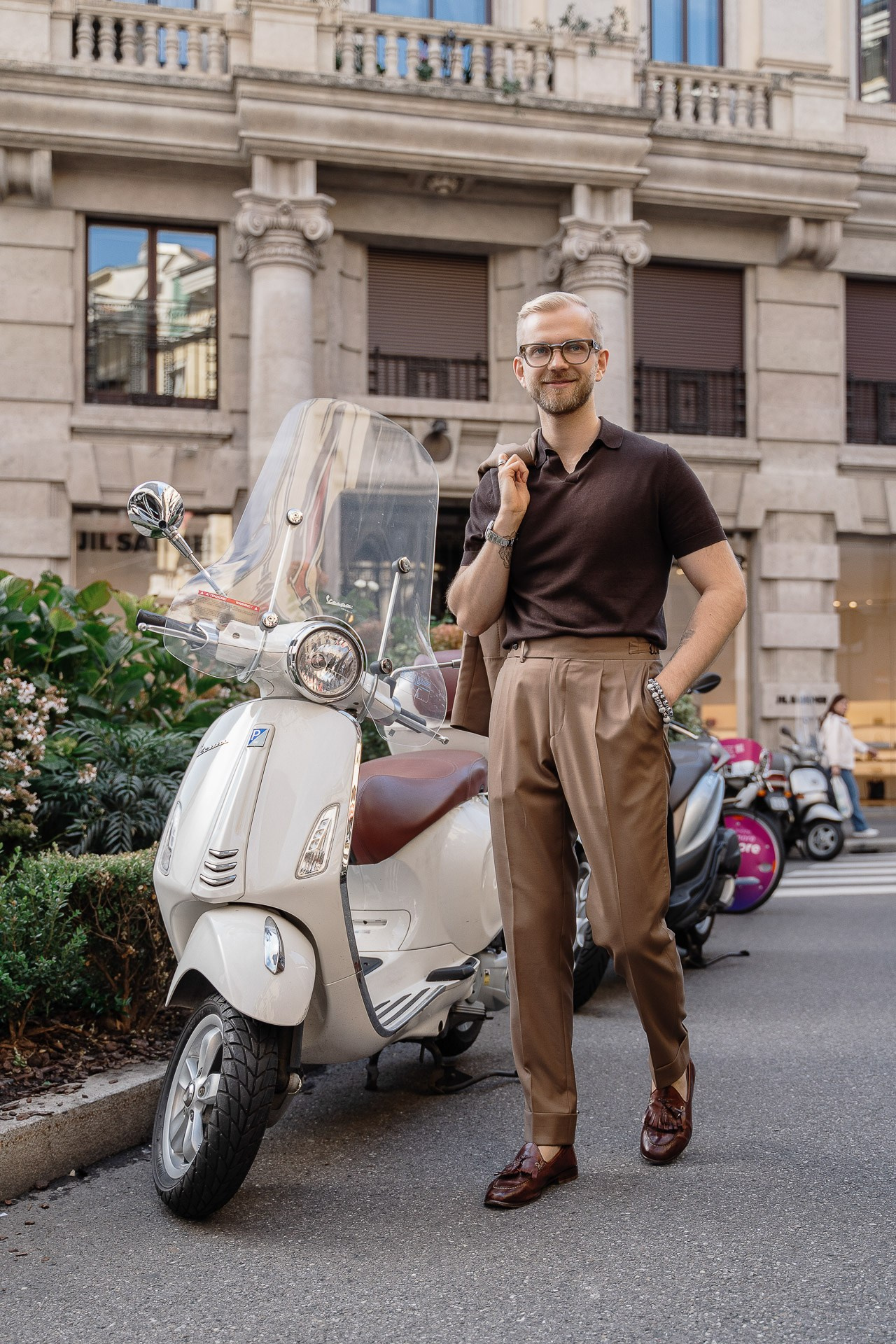 Personal photoshoot in Milan with Vespa scooter and urban background