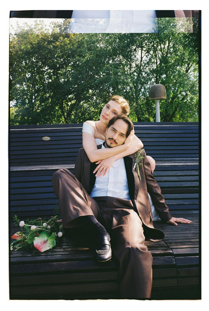 Couple sitting on bench during editorial wedding portraits