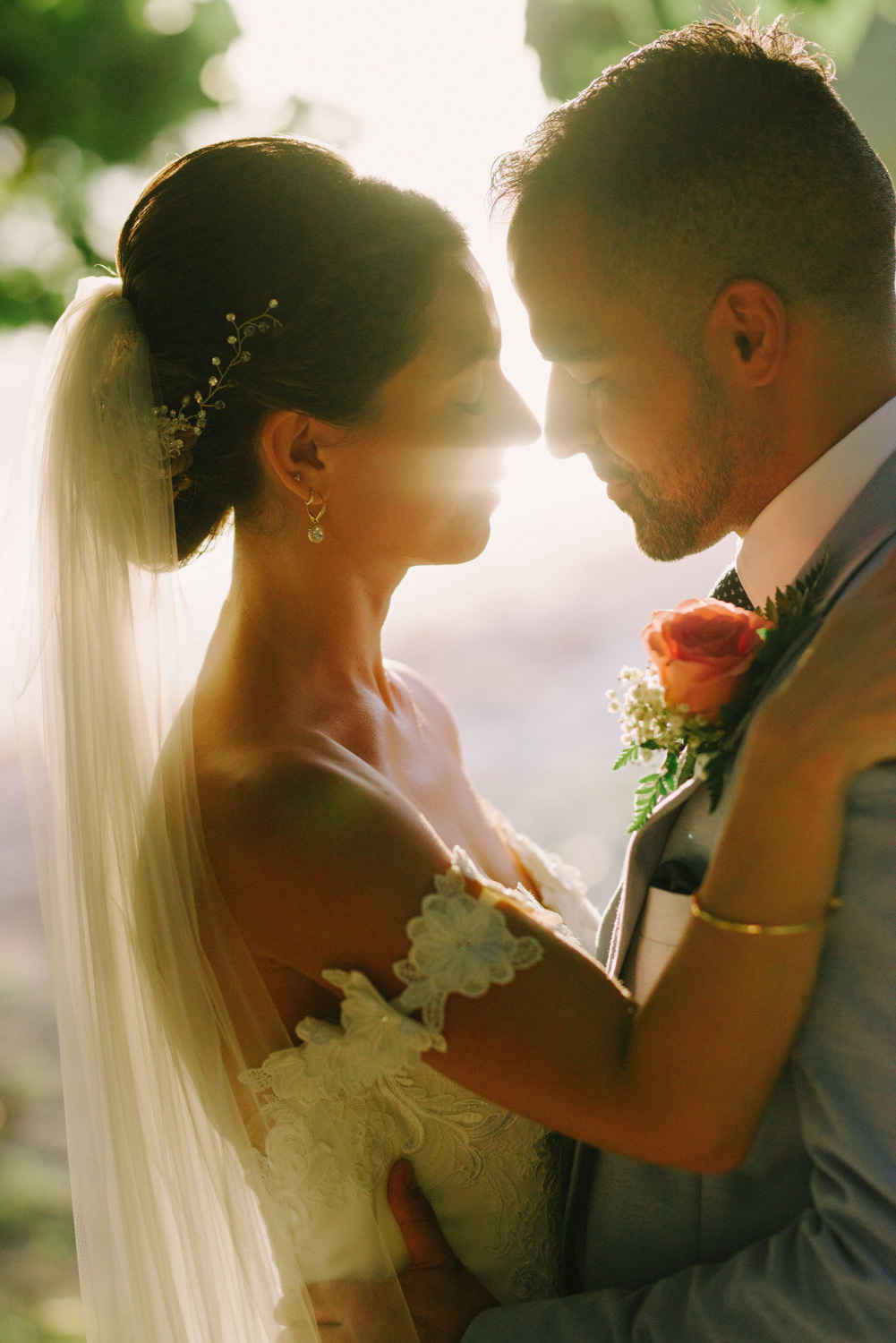 The bride and groom tenderly embrace each other.