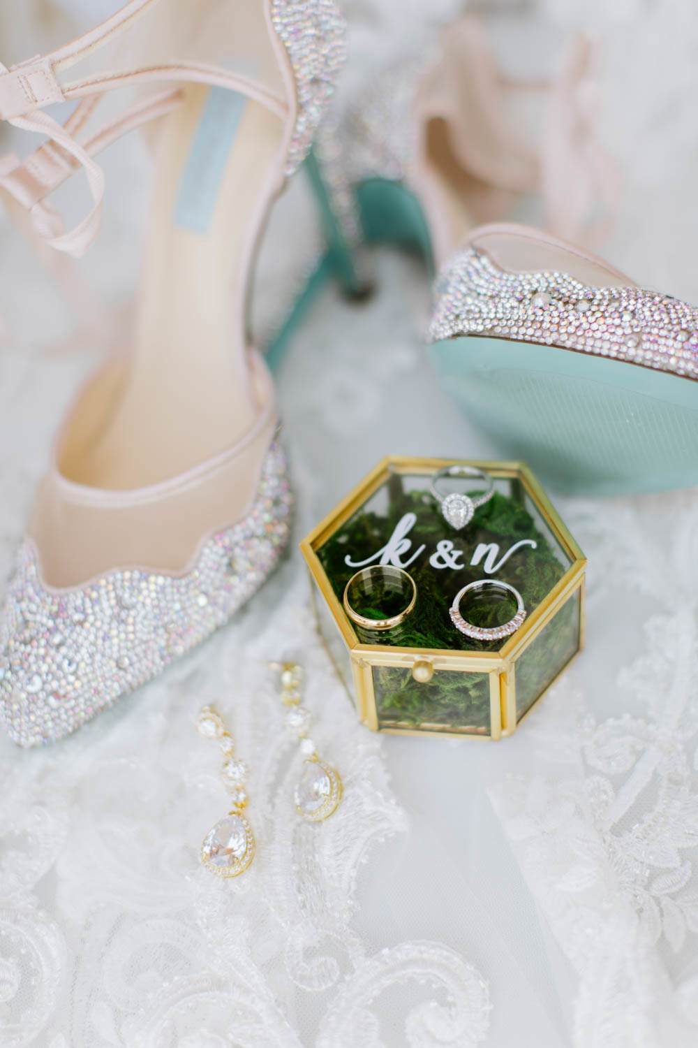 Wedding rings. Shoes and earrings of the bride.