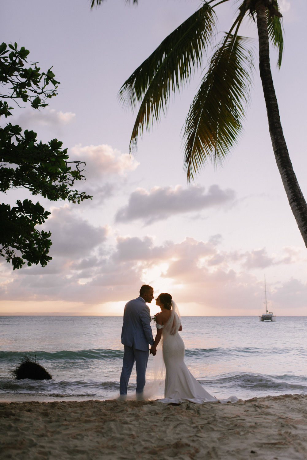 Bride and groom on the background of the sea and the setting sun.