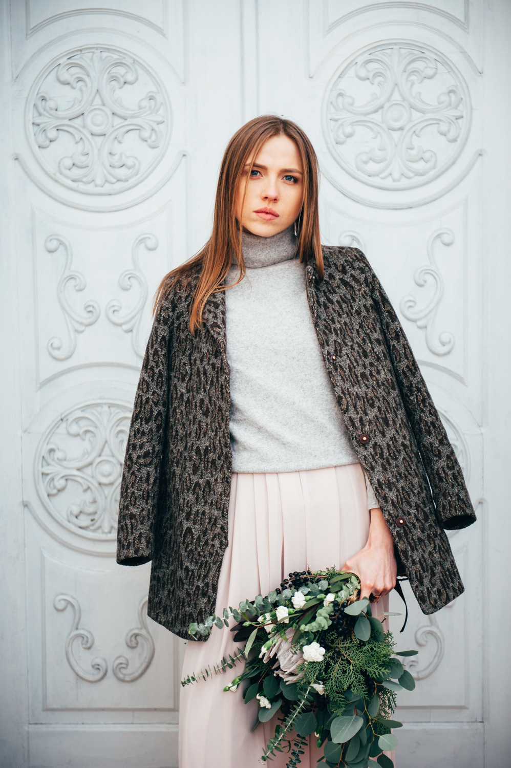 Bride on the background of white doors.