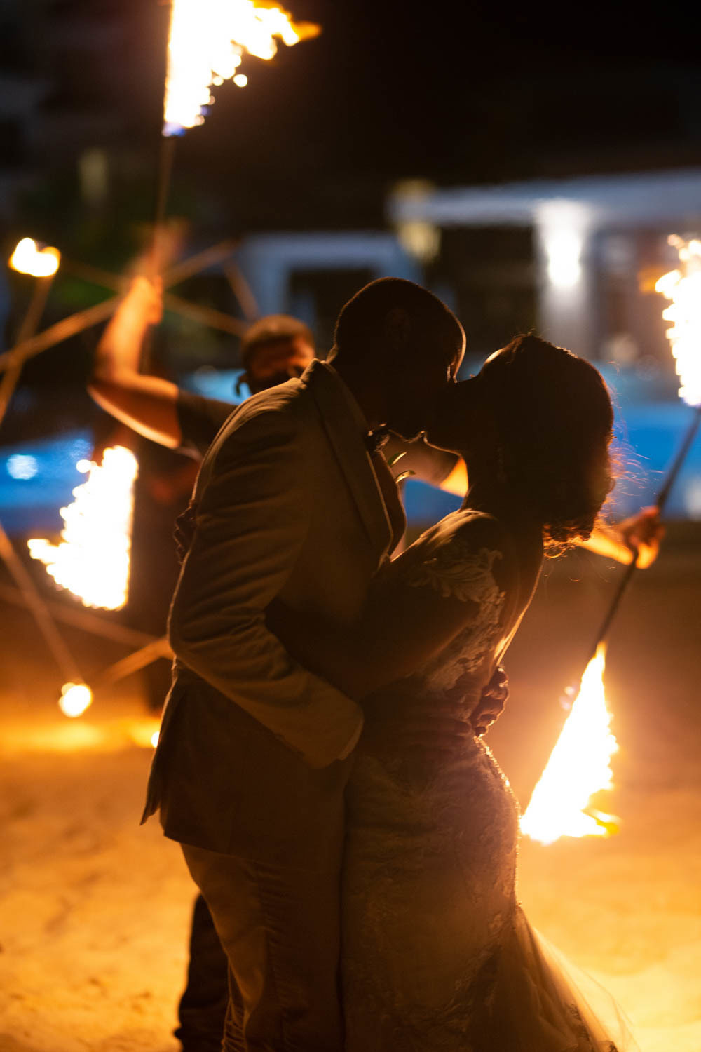 The bride and groom dance and kiss each other.
