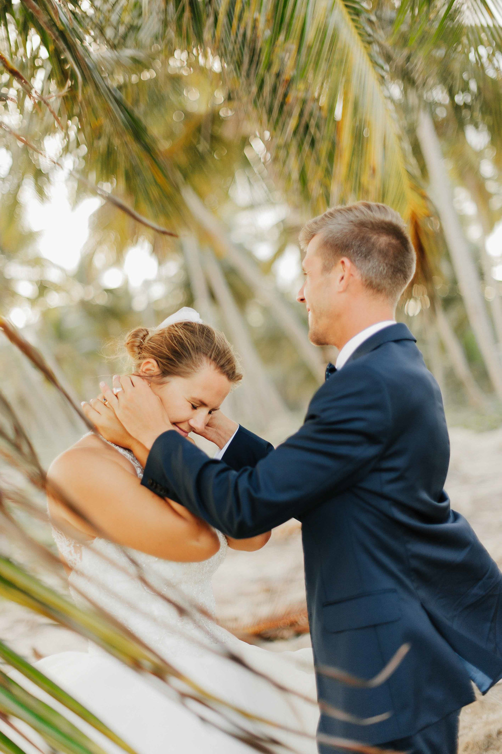 Bride and groom on the background of palm trees.