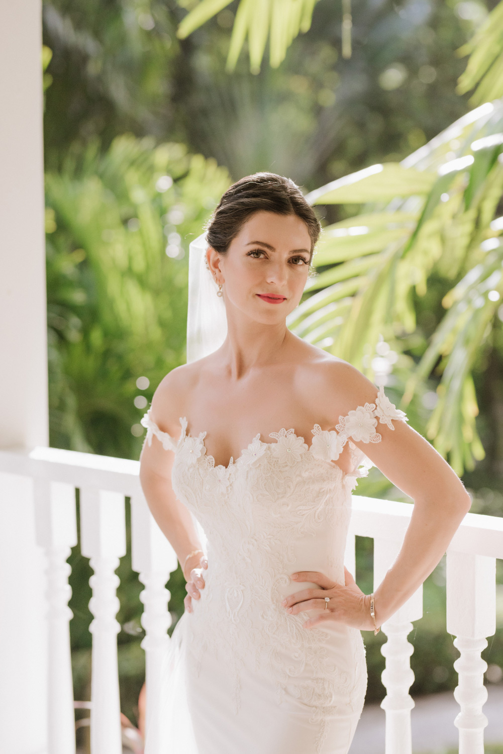 Festive view of the bride on the background of palm trees.