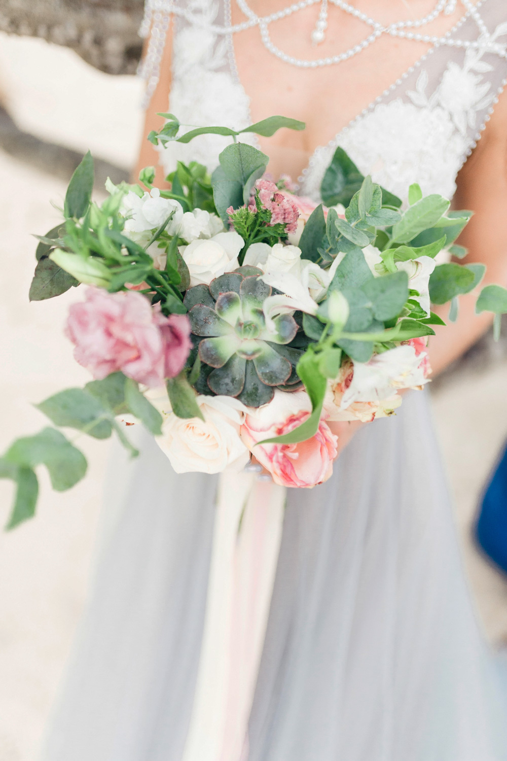 Wedding bouquet in the hands of the bride.