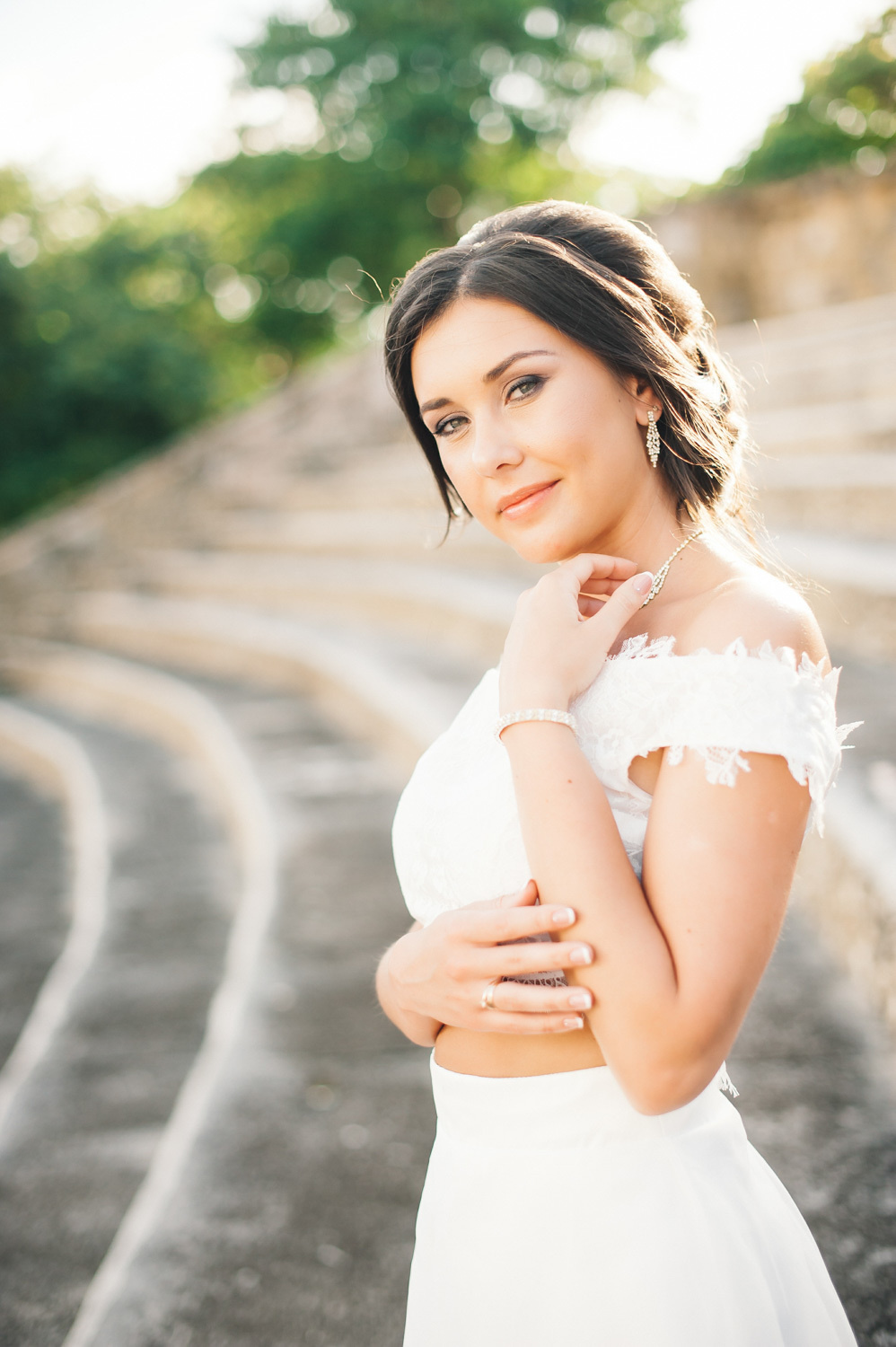 The bride's face on the background of a stone arched staircase.