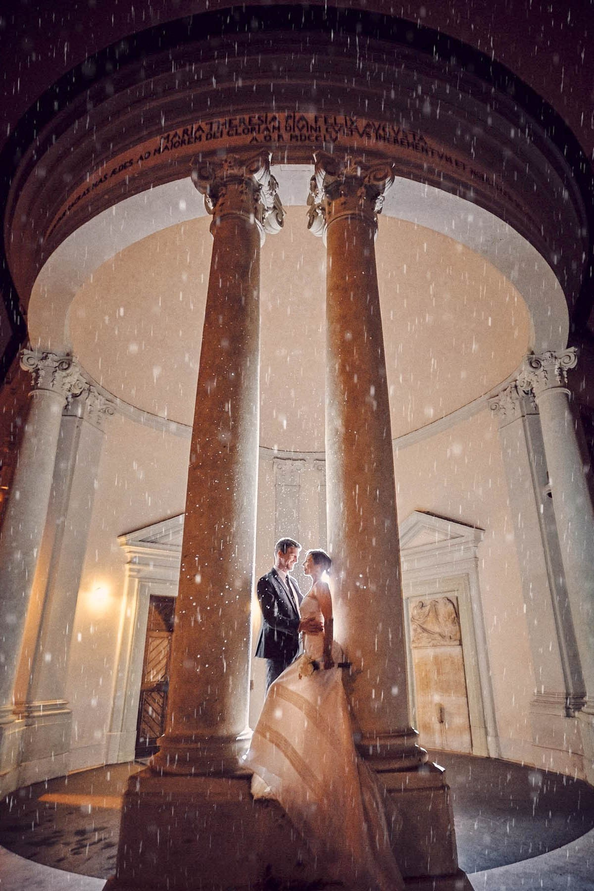 Couple posing in the rain at night, Prague Castle destination wedding